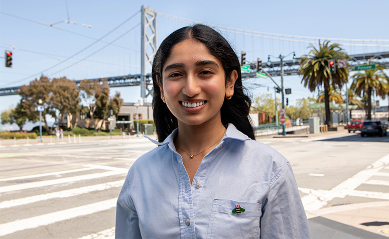 USF student posing in front of the bay bridge