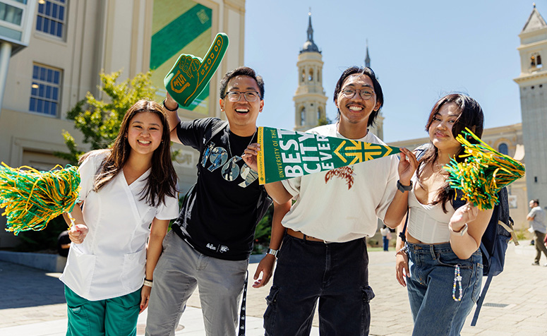 Group of USF students posing with fan gear