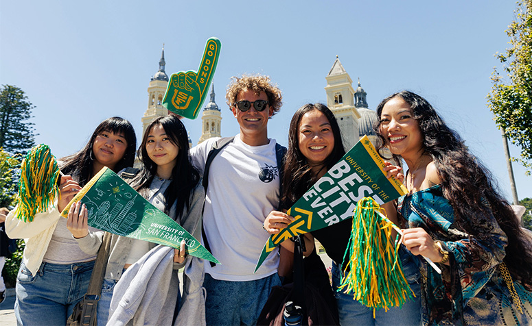 Group of students posing with USF merch