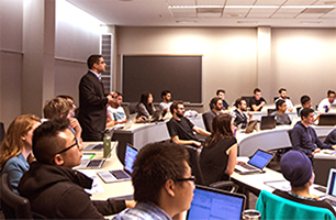 An instructor lecturing in a classroom