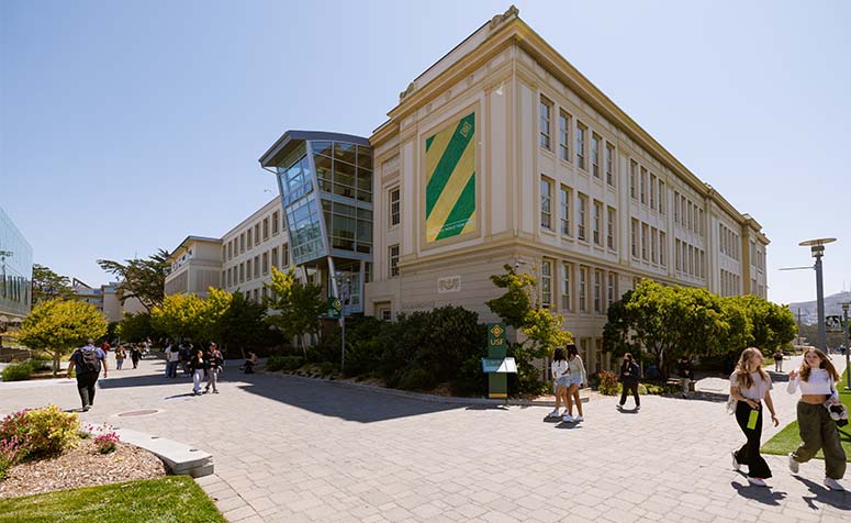 USF main campus building with students walking by