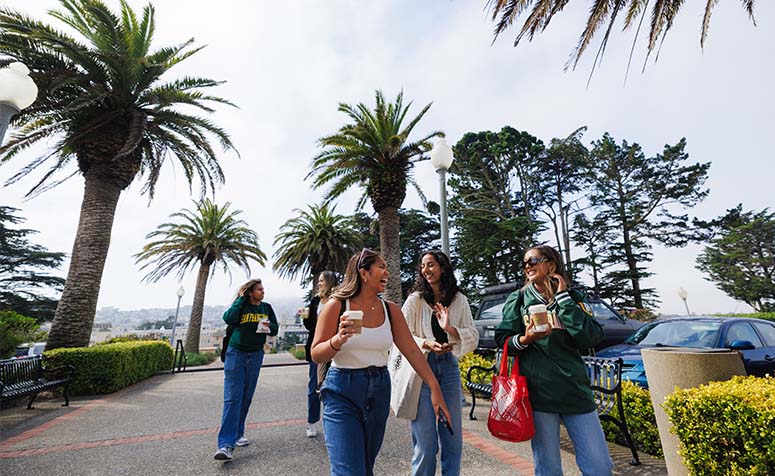 Group of USF students walking on Lone Mountain campus