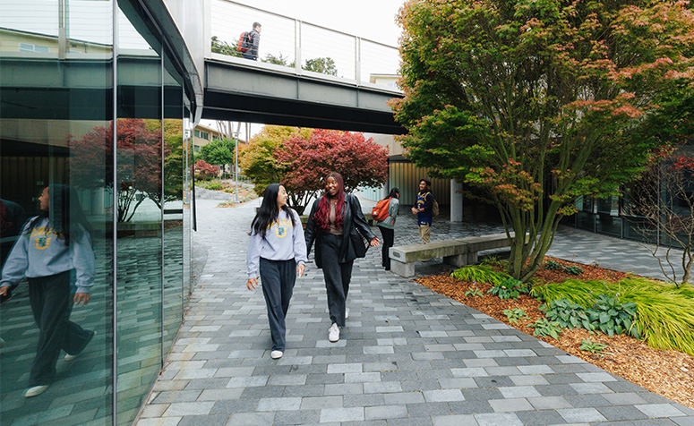 Two USF students walking on main campus