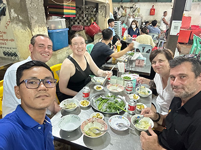 USF Students and Faculty sharing a meal in Cambodia