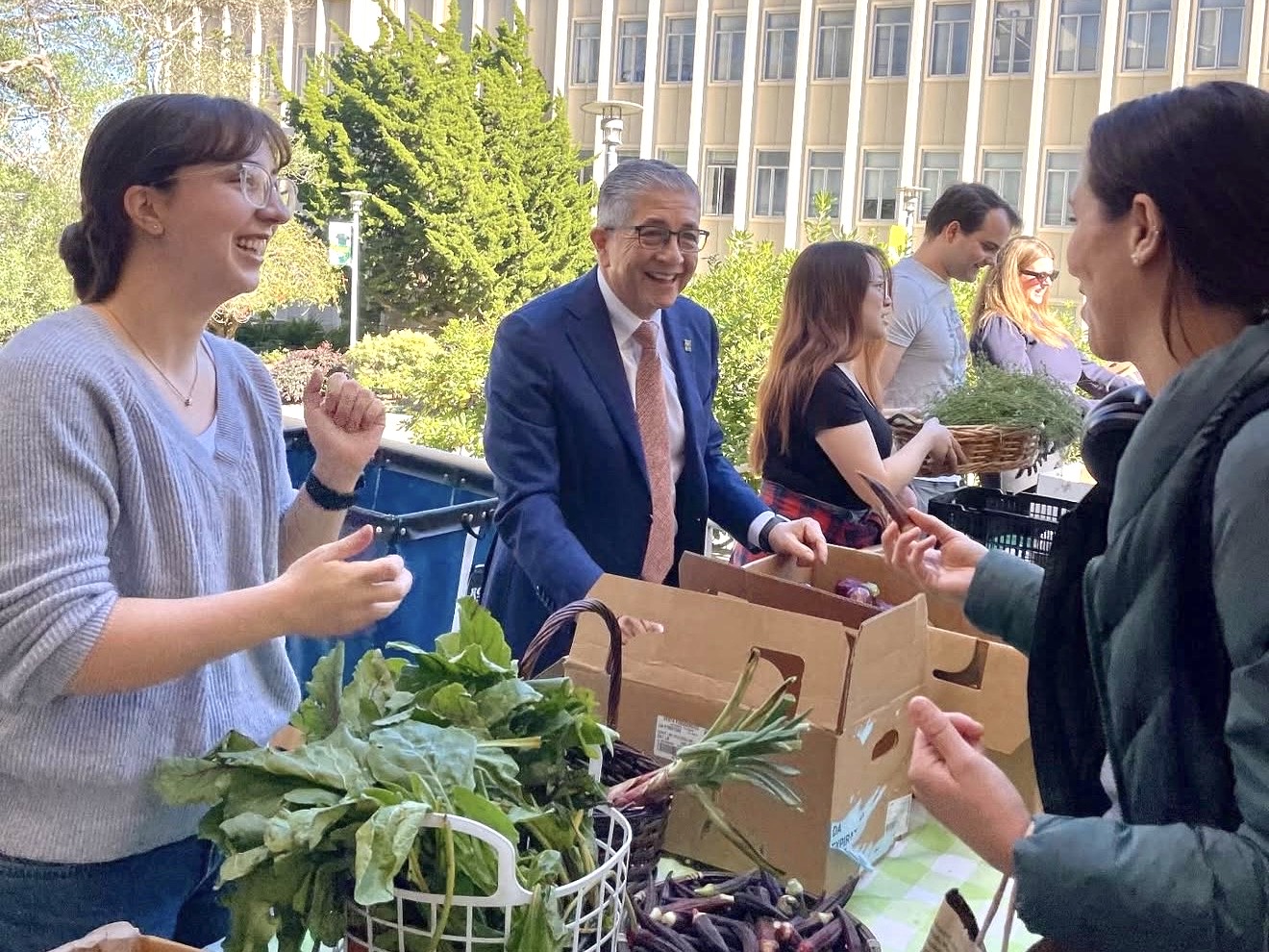 people handing out fresh produce