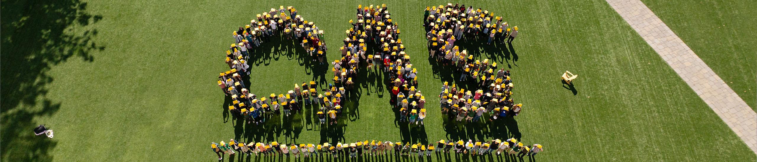 usf community members form the letters CAS