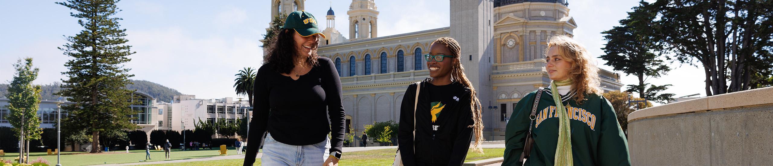 Three students walking on together on campus