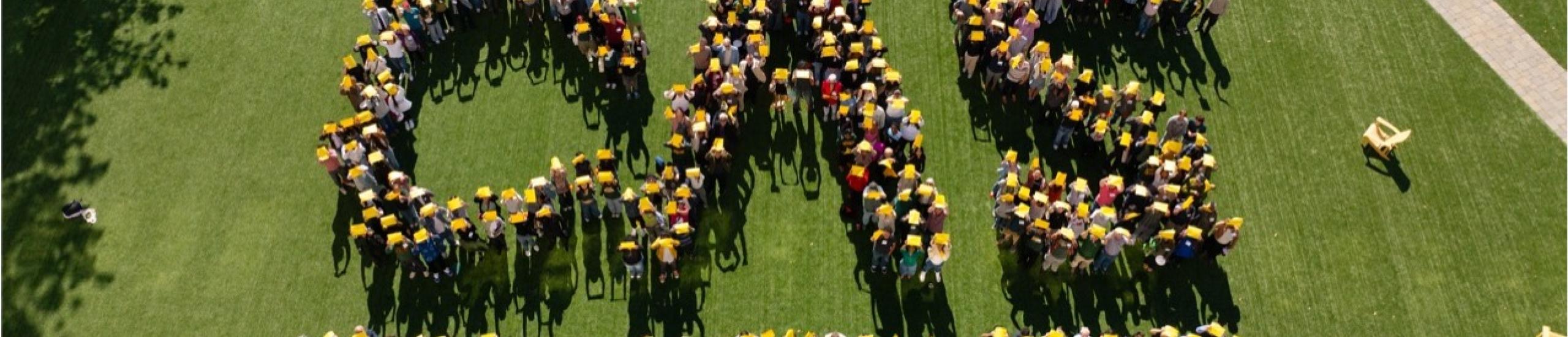 usf community members form the letters CAS