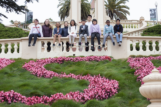 students in front of USF flowers