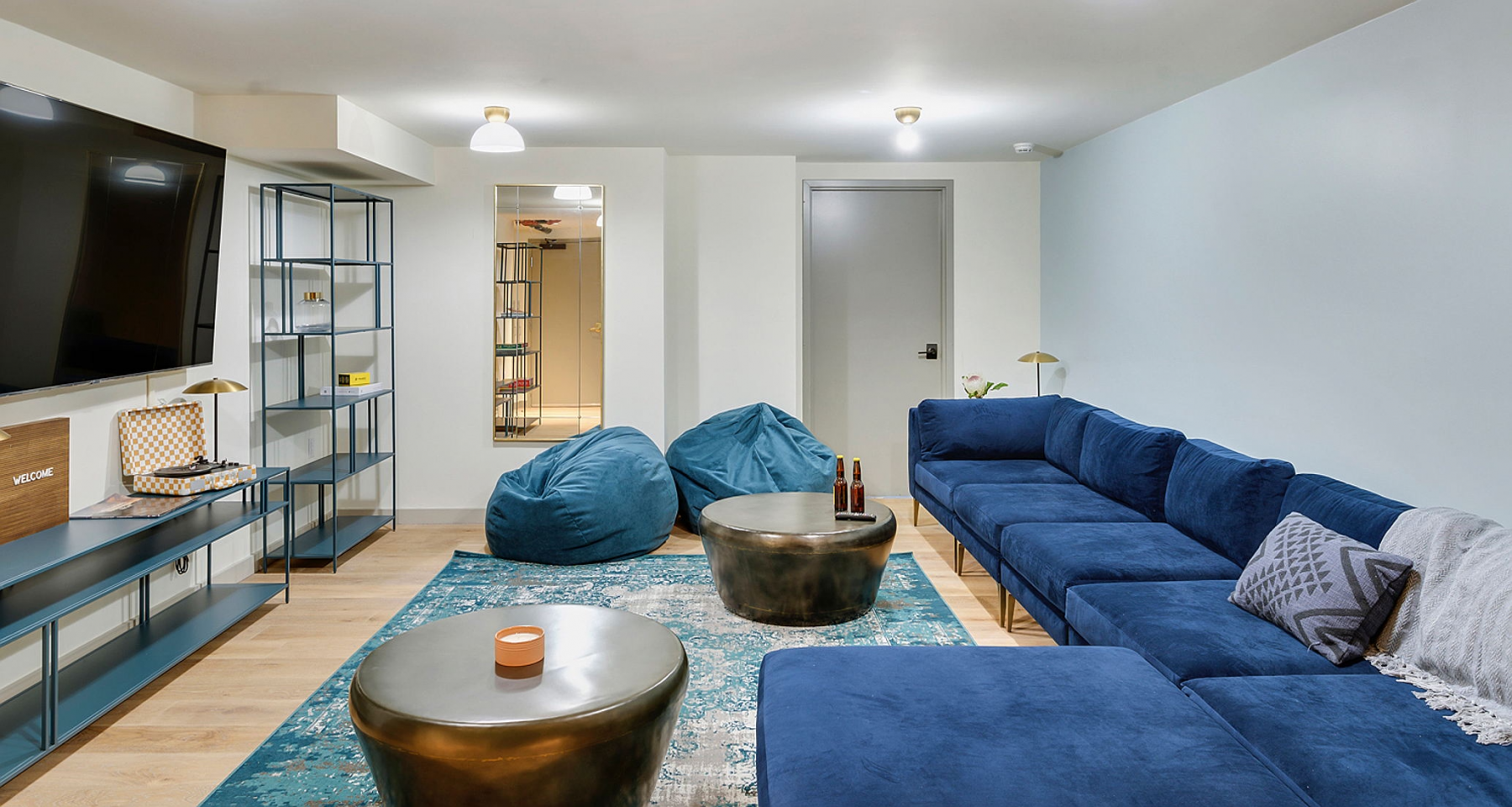 Common living room with blue couch, beanbags, and other decor