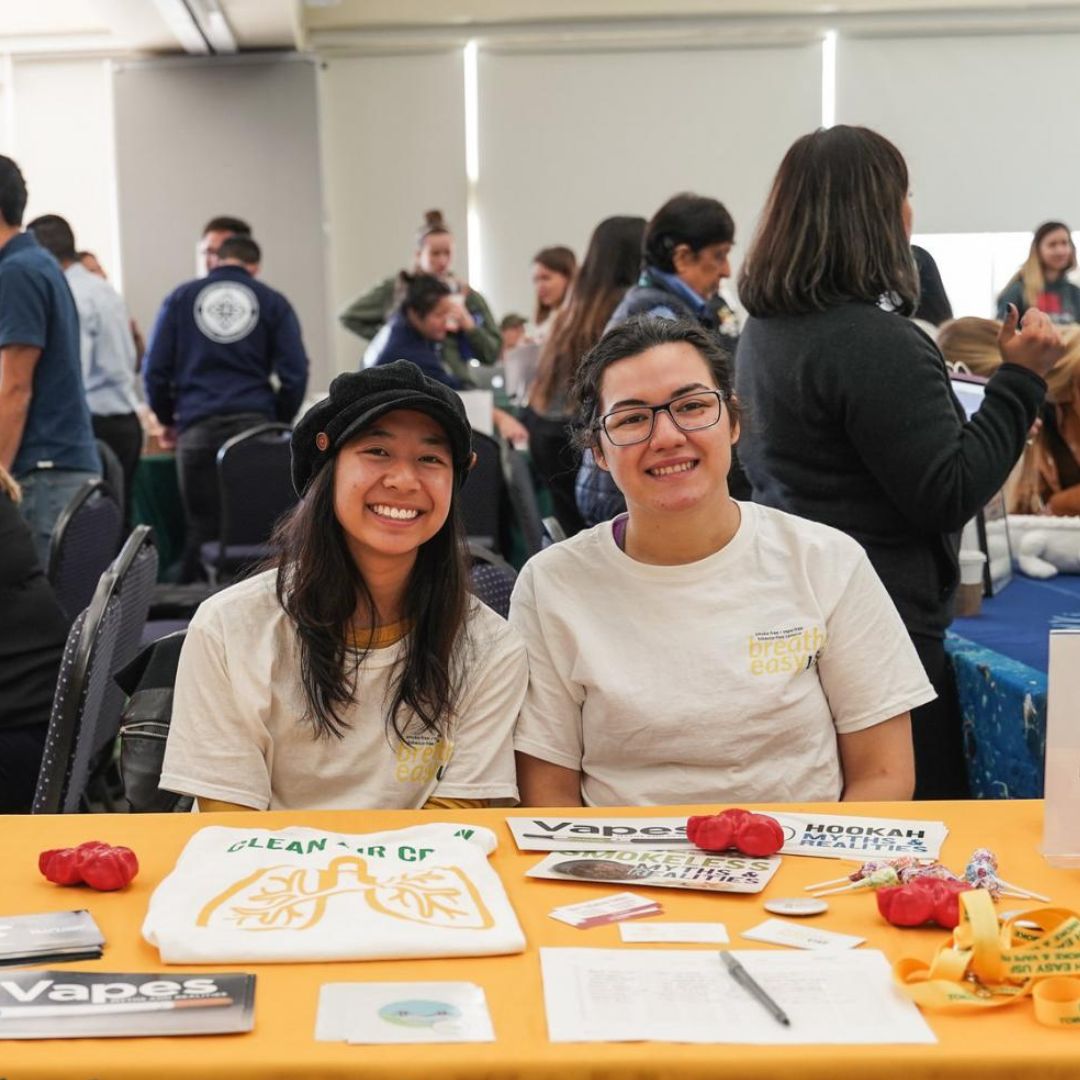 Two students tabling at event
