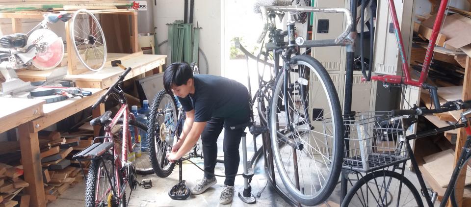 student working on bike