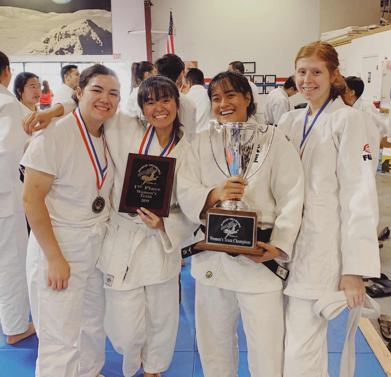 judo participants holding up trophy