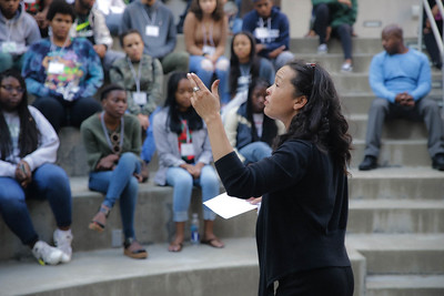 Faculty member lecturing in front of a group of students.