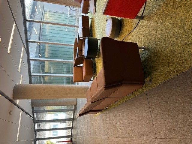 "Windowed wall with seating area in front of it"