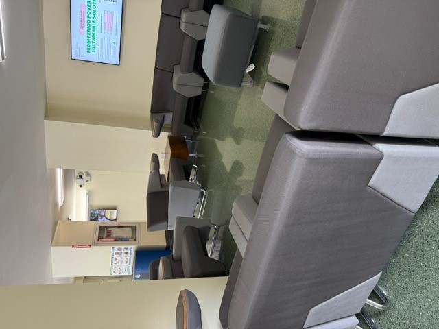 "Seating arranged in a square shape with end tables and a TV"