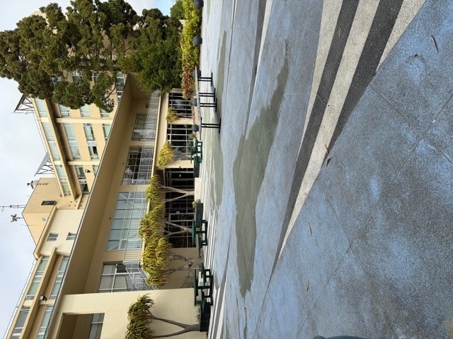 "Courtyard area with building in background and seating"