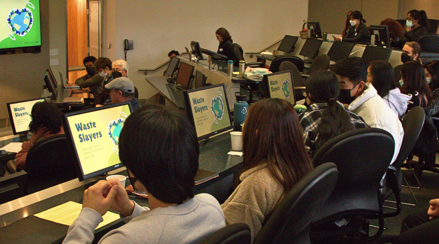 Students in auditorium looking at a presentation.