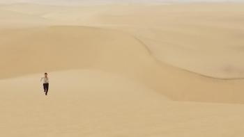boy running in sand desert