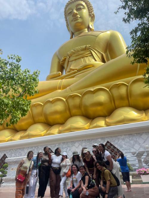 students in front of Buddha statue