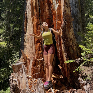 photo of Izy Well in front of a redwood tree