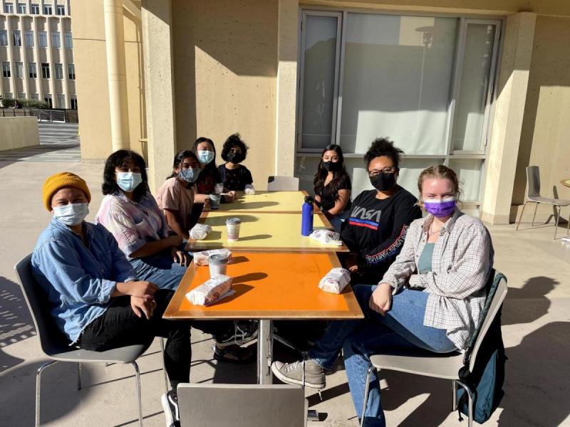 Students sitting around a table outside the UC