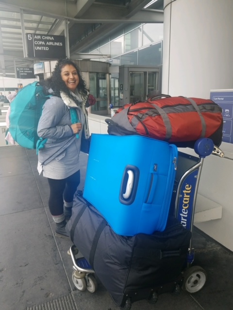 Woman with four bags of luggage