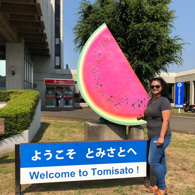 Woman next to watermelon statue in Tomisato, Japan