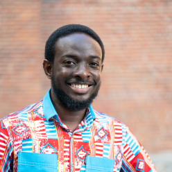 Emmanuel portrait in a blue and orange shirt